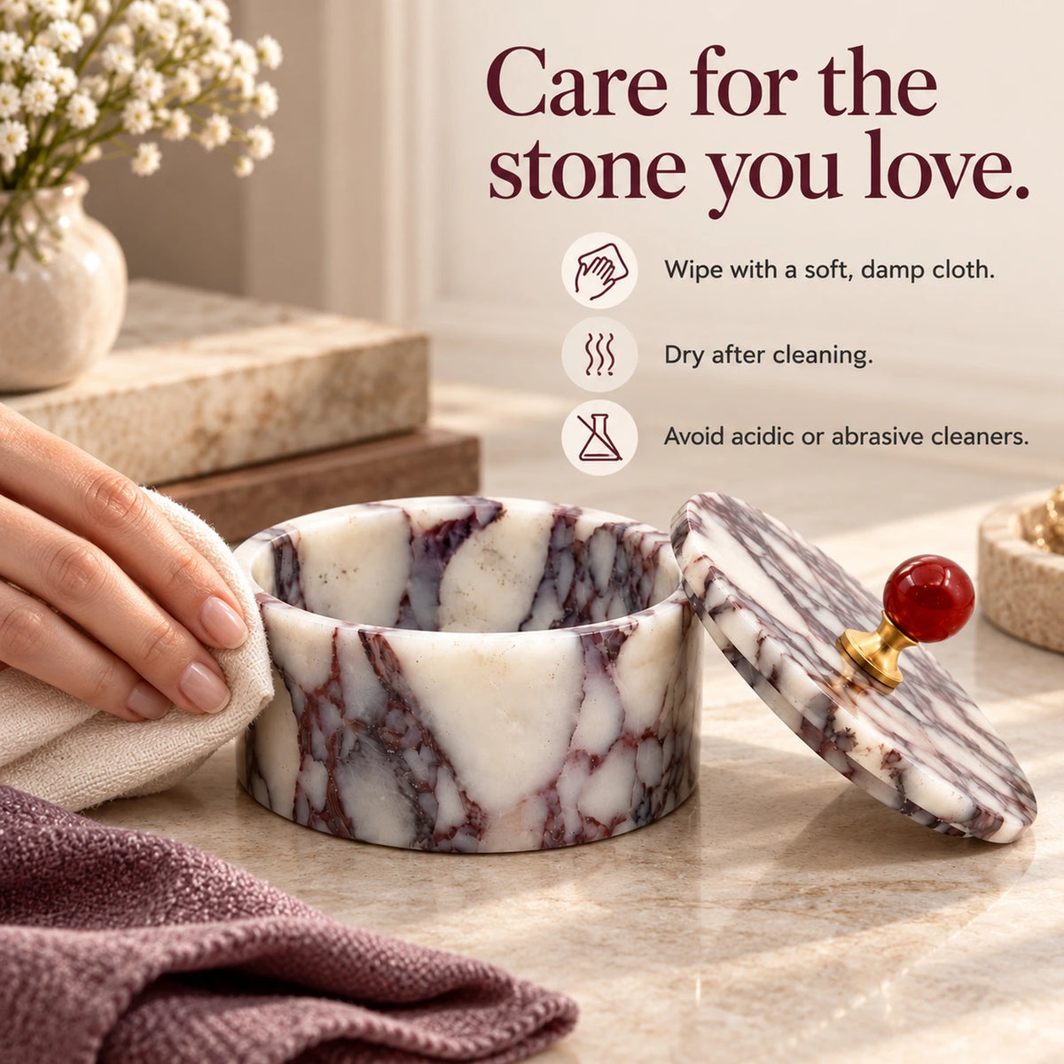 Hand wiping a purple marble jewelry box with a soft cloth, alongside instructions to dry after cleaning and avoid acidic or abrasive cleaners.