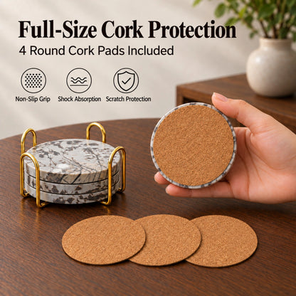 A hand showing the cork backing of a Guohua stone coaster, beside three loose cork pads and a coaster holder.