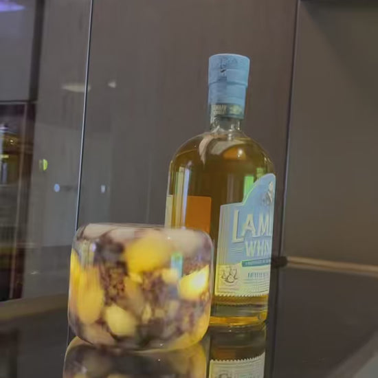 Calacatta Viola purple marble touch lamp by Marmor lighting up a home bar display