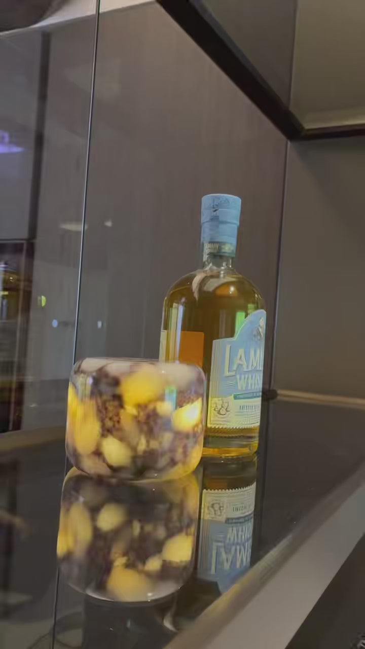 Calacatta Viola purple marble touch lamp by Marmor lighting up a home bar display